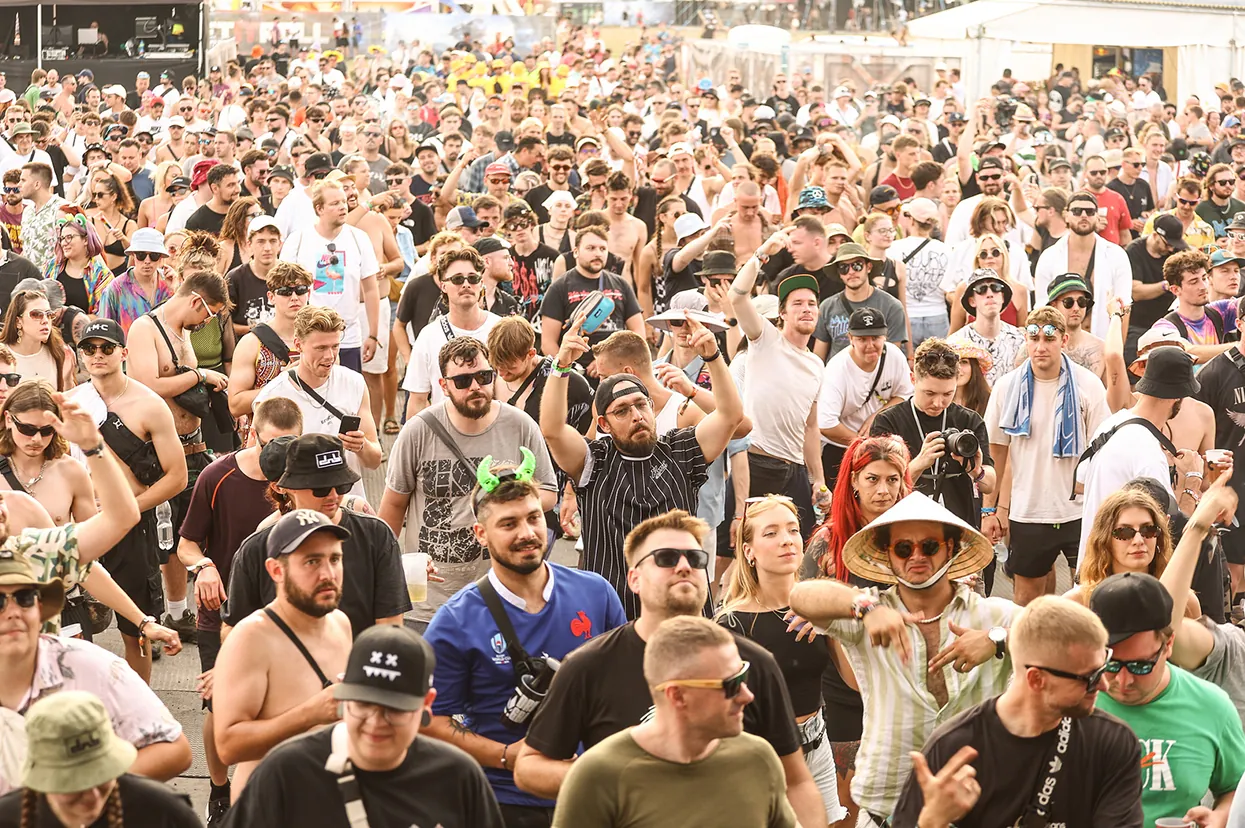 Packed daytime crowd in front of a stage
